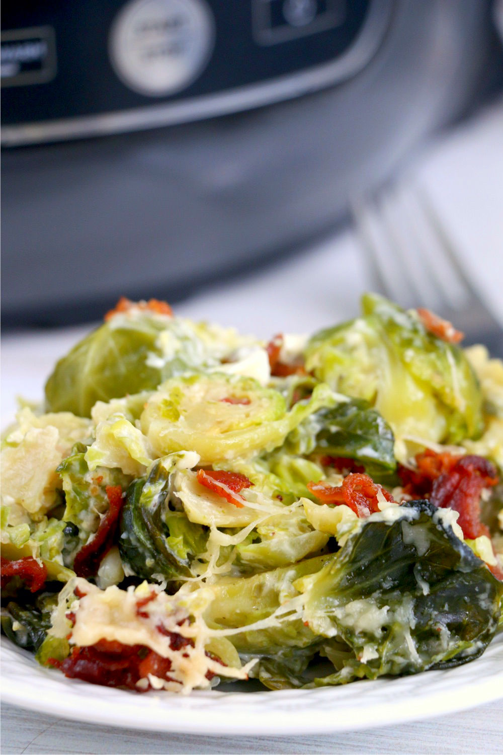 Plate of Brussels sprouts in front of a Ninja Foodi