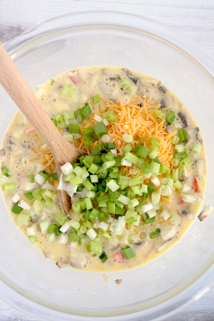 Adding green onions to egg mixture