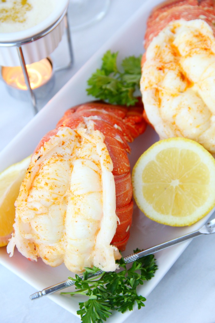 lobster tails with lemon on plate