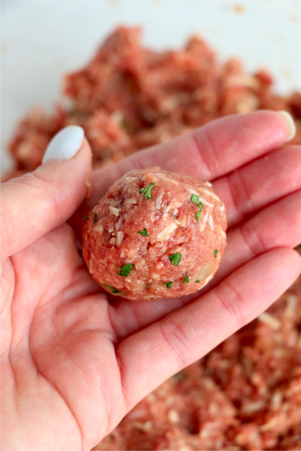 formed meatball in hand
