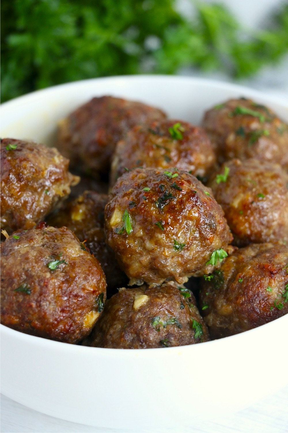 bowl of meatballs garnished with parsley