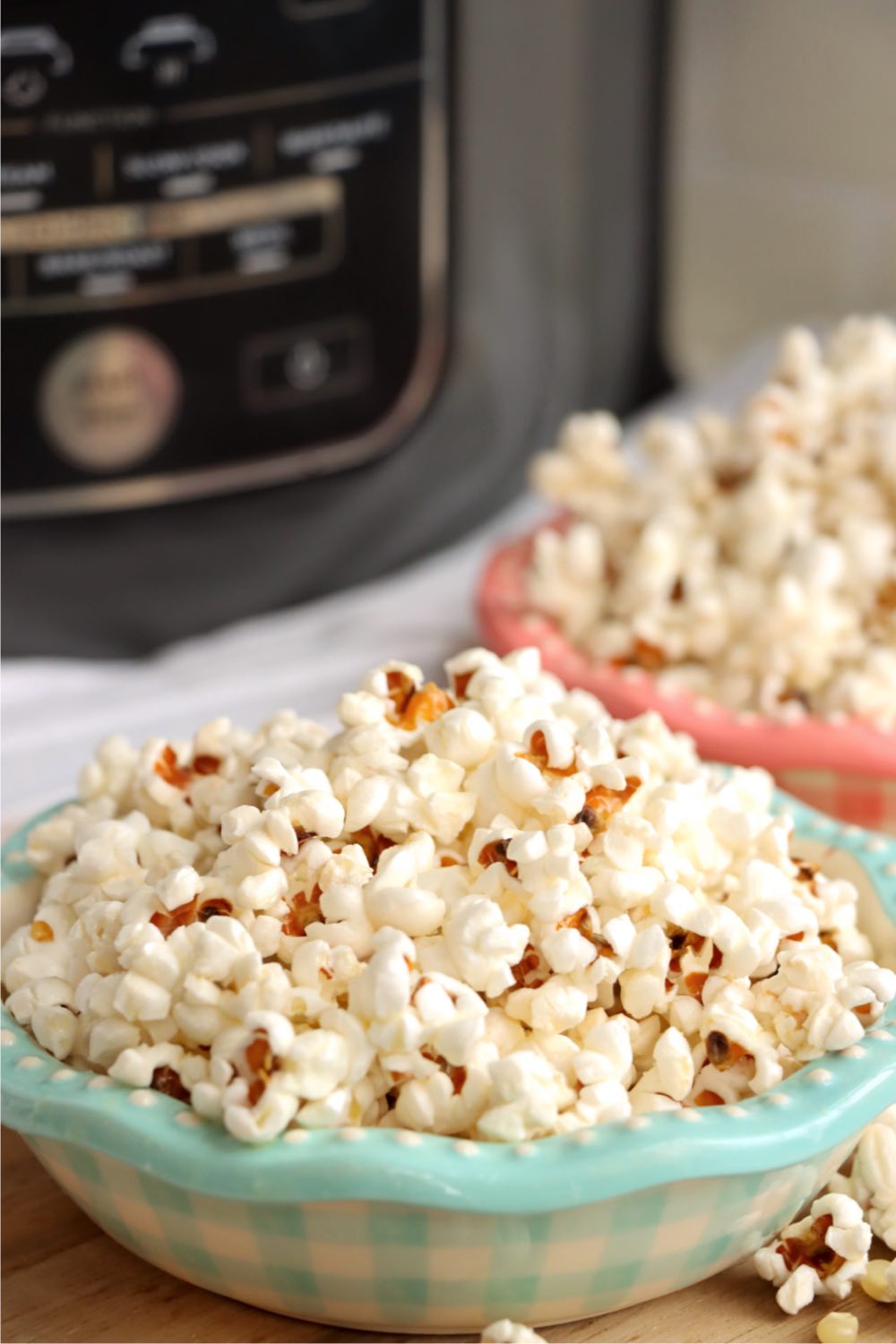 bowls of popcorn in front of Ninja Foodi