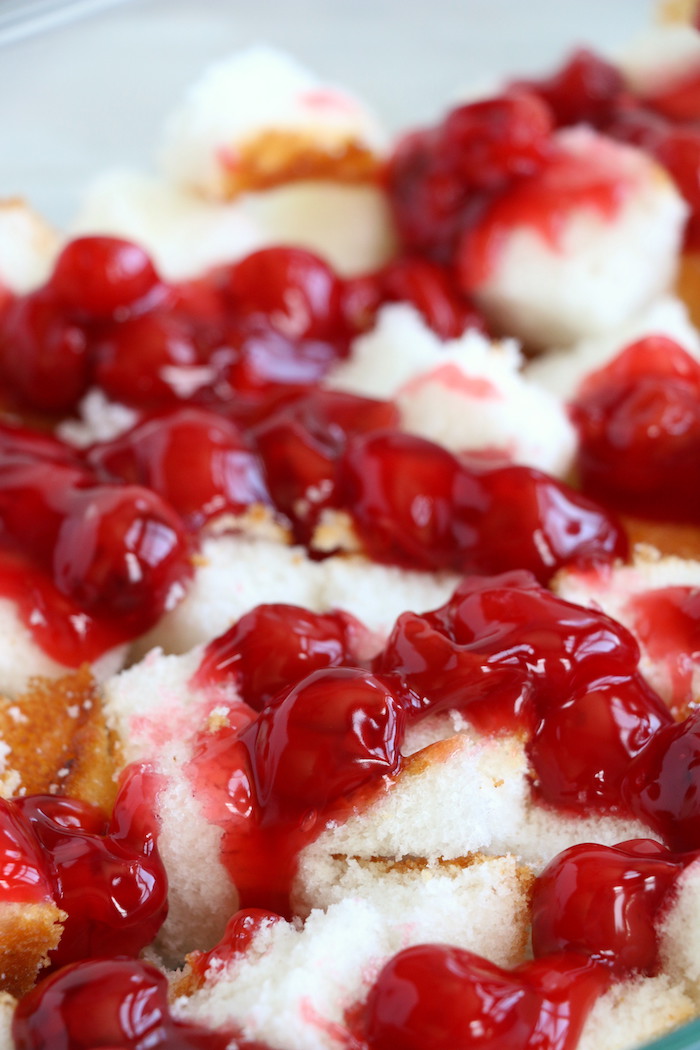 No Bake Cherry Dump Cake - An easy, no-bake cherry trifle dessert with layers of angel food cake, sour cream, pudding, cherry pie filling and whipped topping.