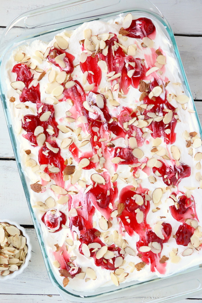 No Bake Cherry Dump Cake - An easy, no-bake cherry trifle dessert with layers of angel food cake, sour cream, pudding, cherry pie filling and whipped topping.