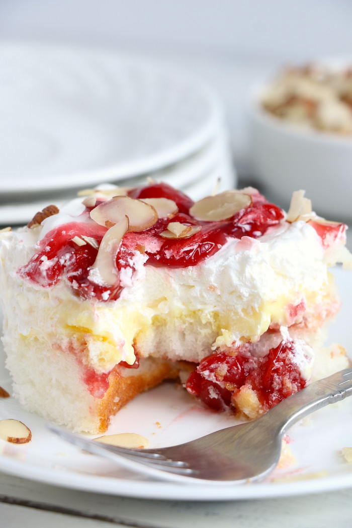 No Bake Cherry Dump Cake - An easy, no-bake cherry trifle dessert with layers of angel food cake, sour cream, pudding, cherry pie filling and whipped topping.