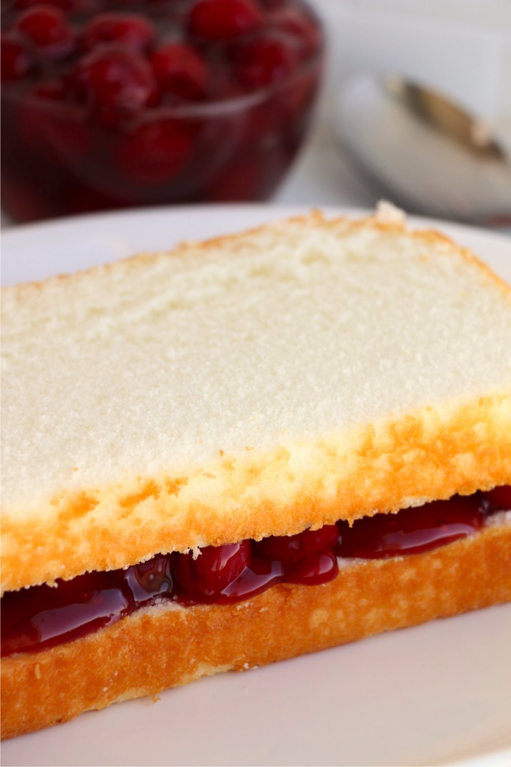 layers of pound cake with canned cherries in the middle