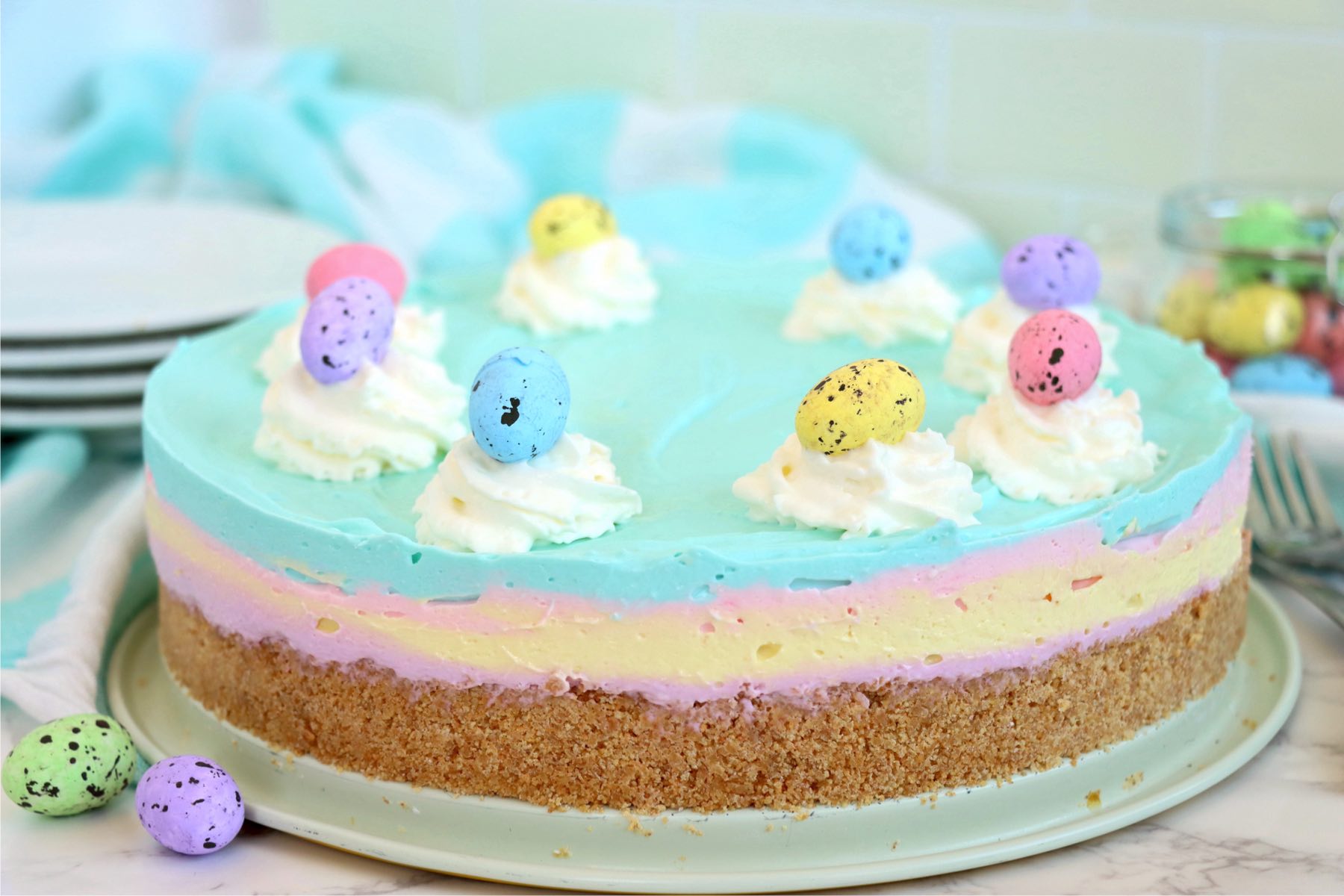 Pastel-layered cheesecake with mini chocolate Easter eggs