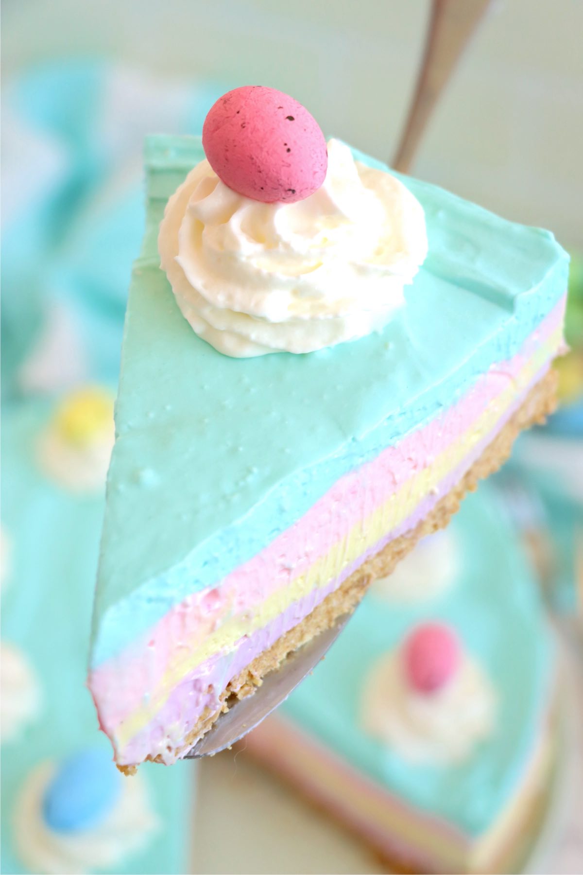 Piece of cheesecake being held out on a cake server