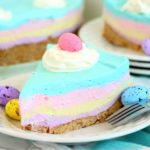 small white plate with a piece of layered Easter cheesecake