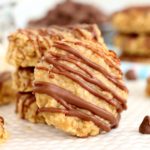 chocolate drizzled preacher cookie in front of stack of cookies