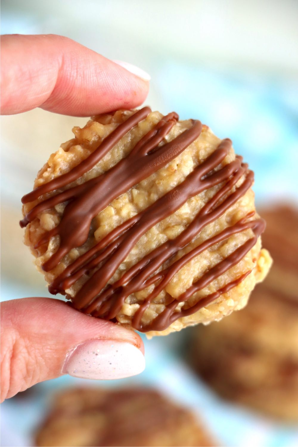 holding up a preacher cookie with two fingers