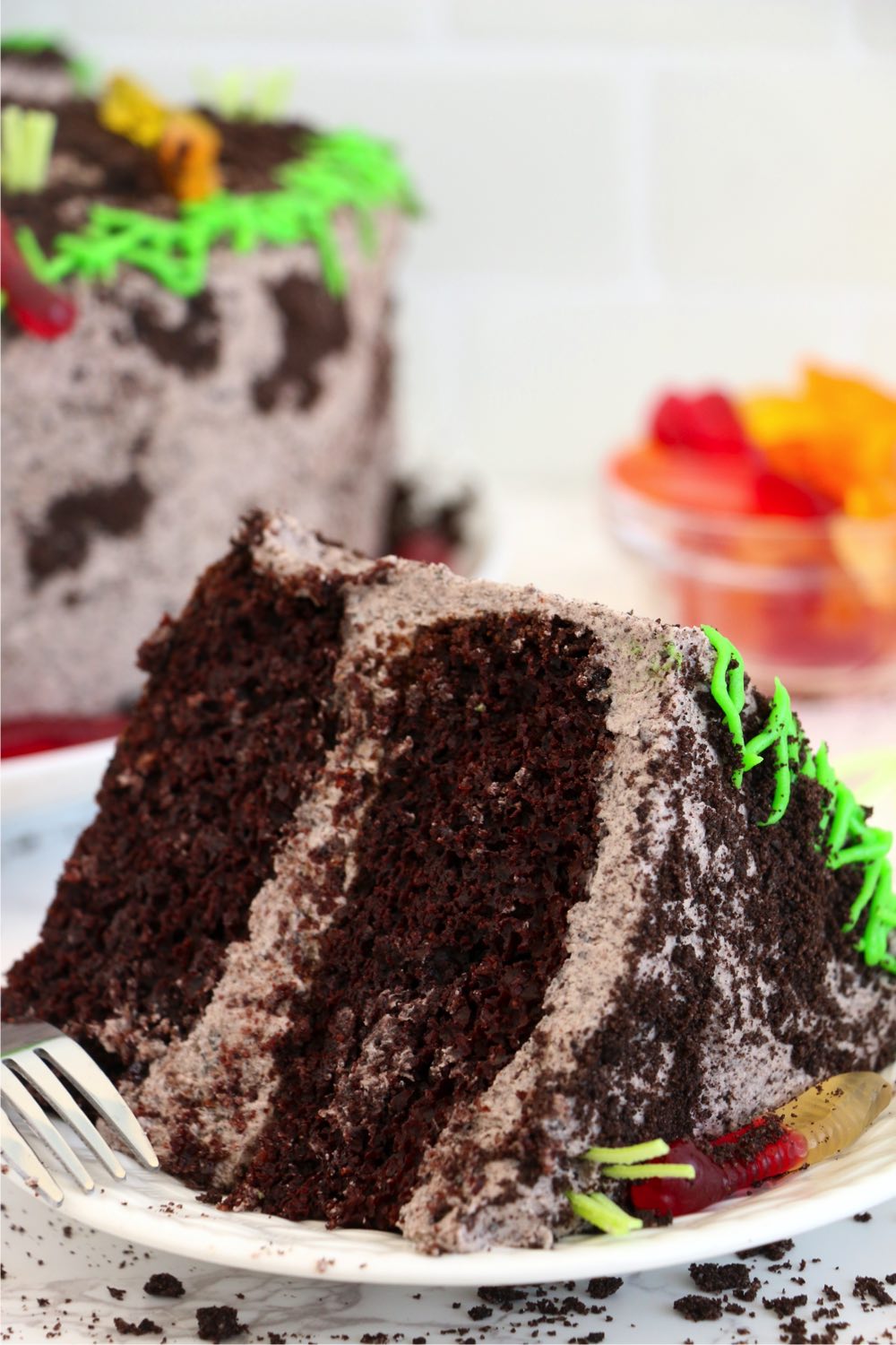 slice of layered chocolate dirt cake on a plate