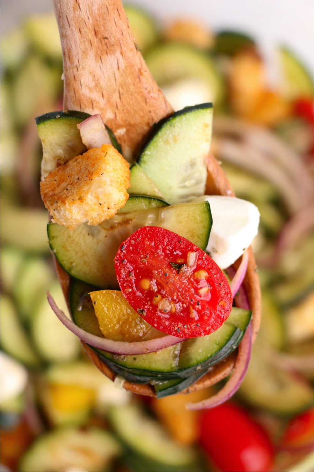 Panzanella Salad on a wooden spoon