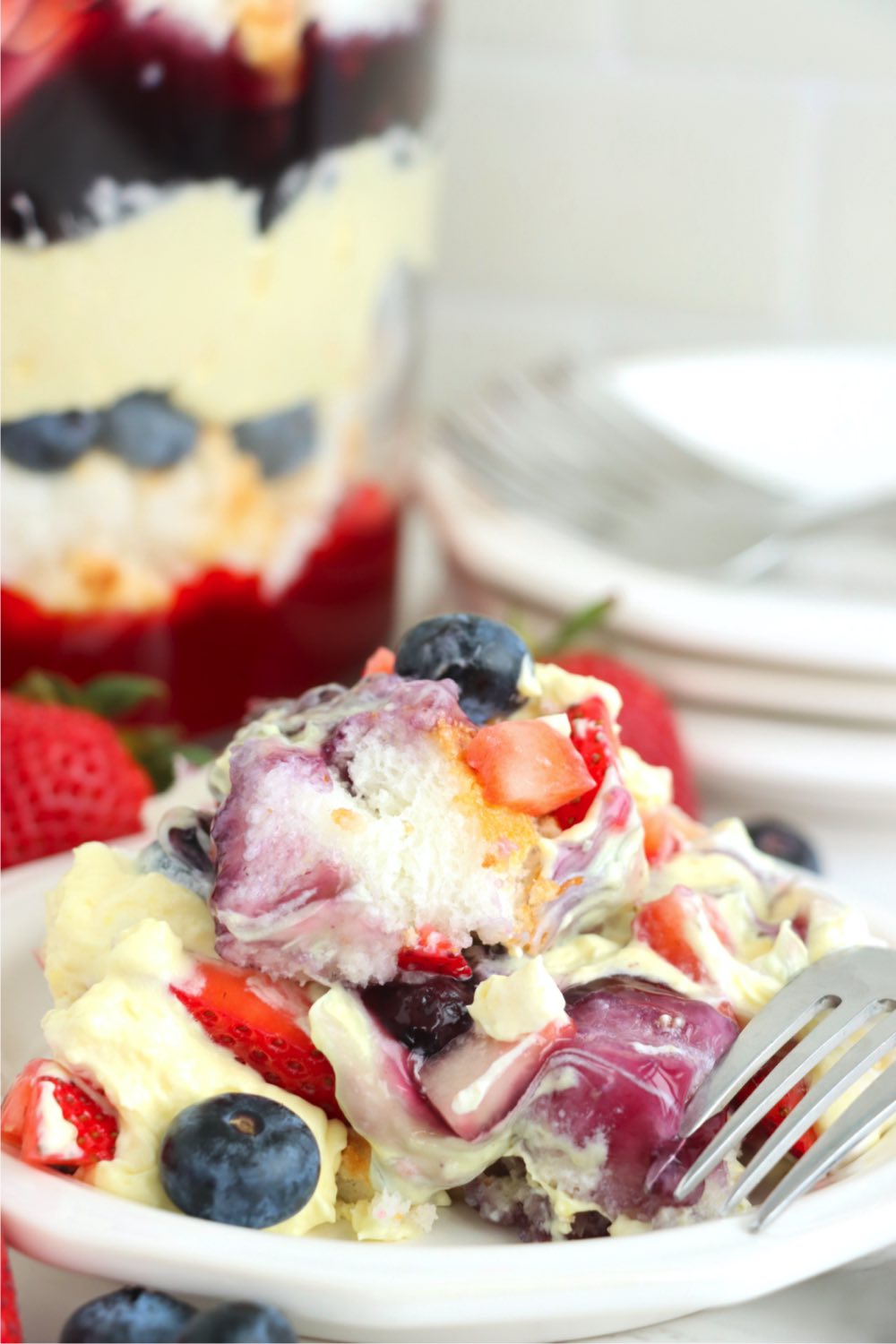 scoop of a berry trifle on a white plate