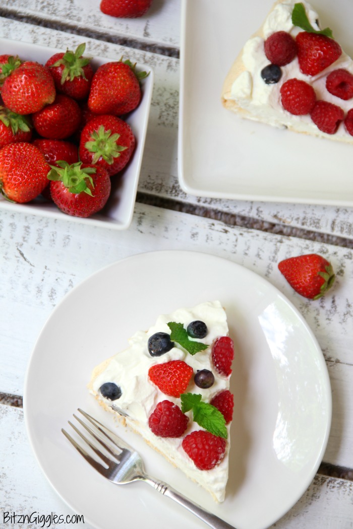Triple Berry Pavlova - This meringue cake is crisp on the outside and soft and light on the inside! Topped with homemade whipped cream and fresh berries, it's such an elegant, light and delicious dessert!