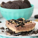 Peanut Butter Oreo Dessert - Fluffy layers of fudge and peanut butter on a Oreo peanut butter cookie crust!