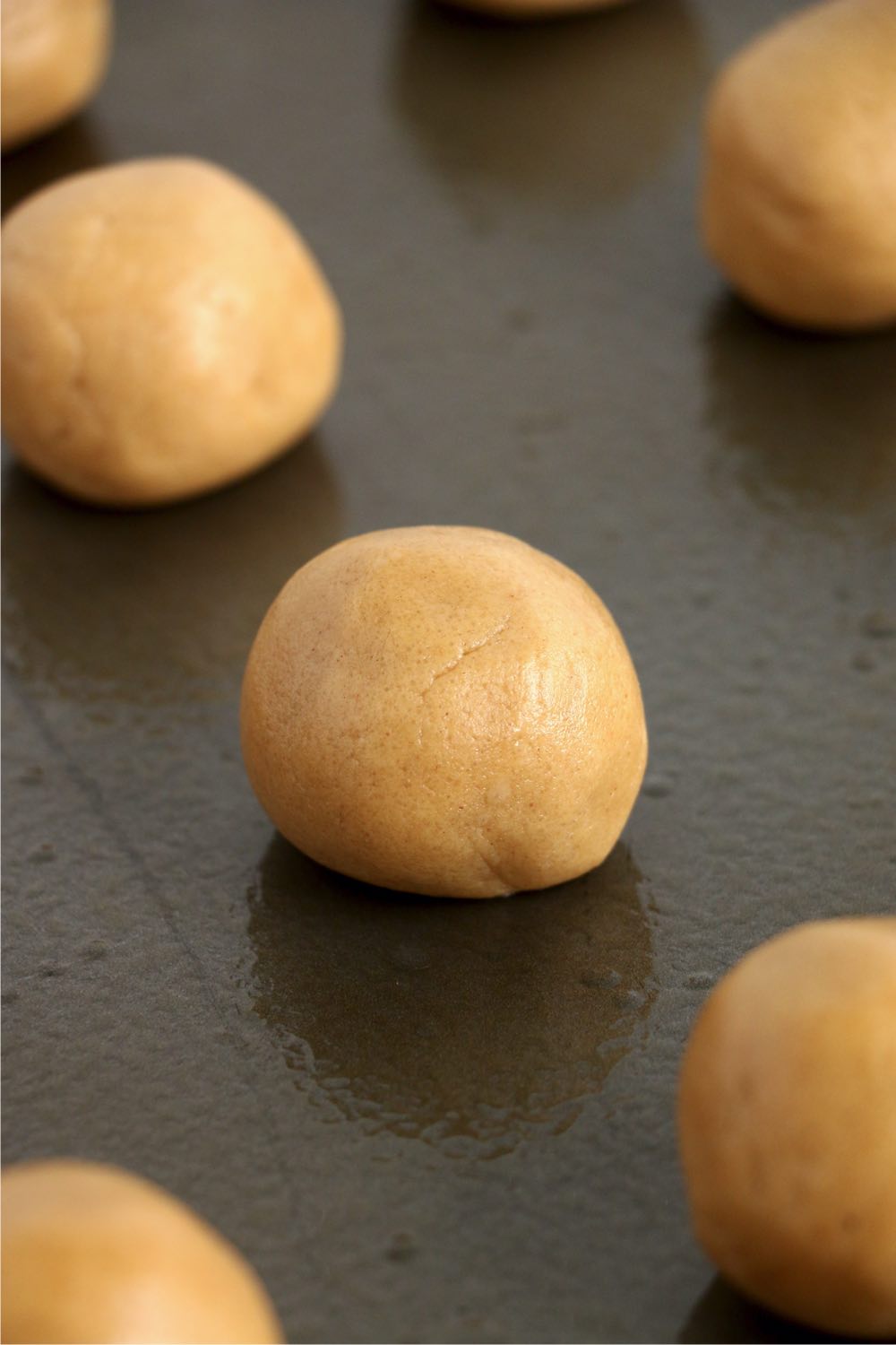 cookie dough balls on a baking sheet