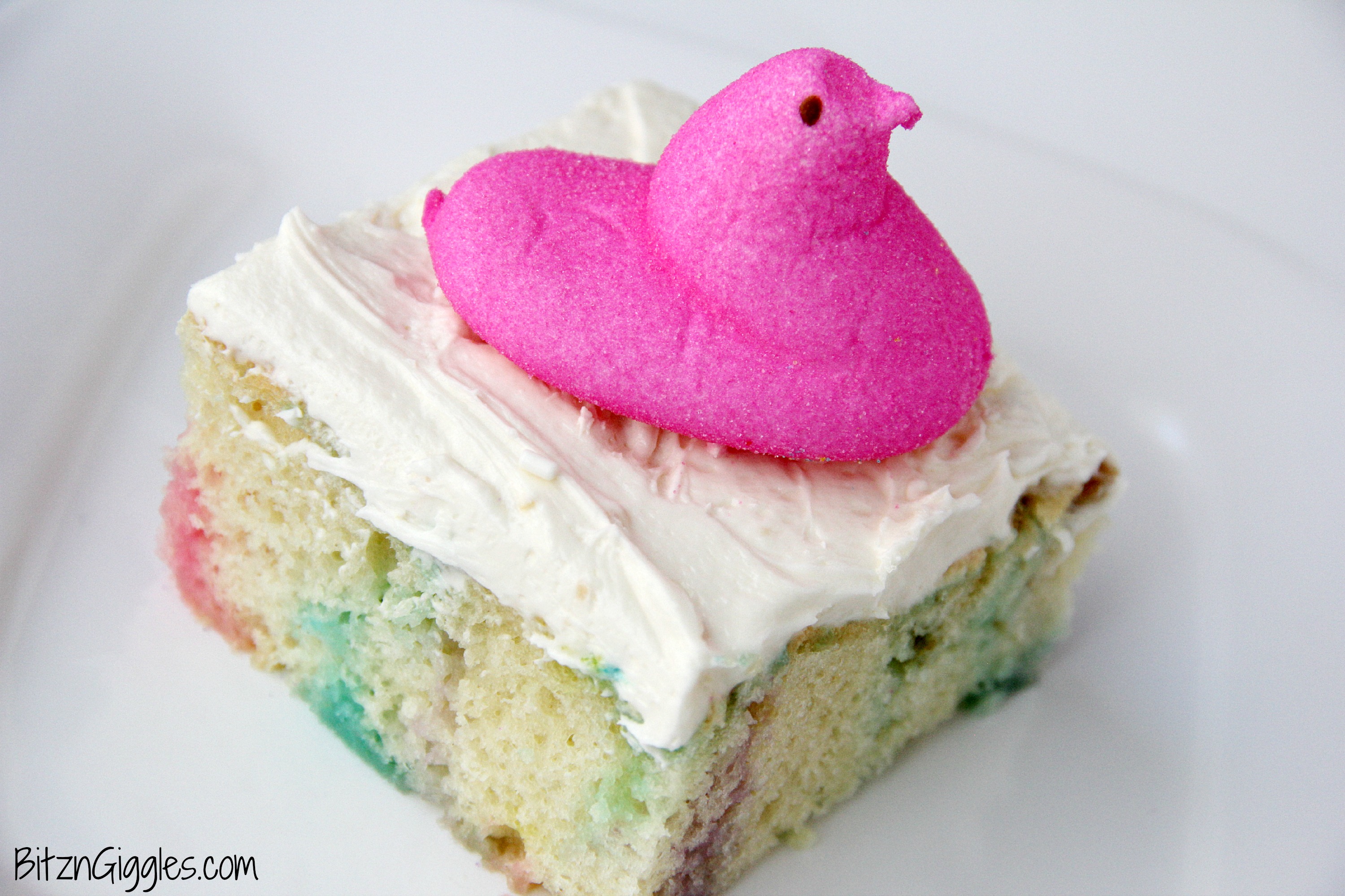Peeps Cake With Marshmallow Frosting - This cake incorporates bits of Peeps right into the baking process, producing a colorful and slightly sweetened cake with a fluffy, marshmallow frosting that literally melts in your mouth!