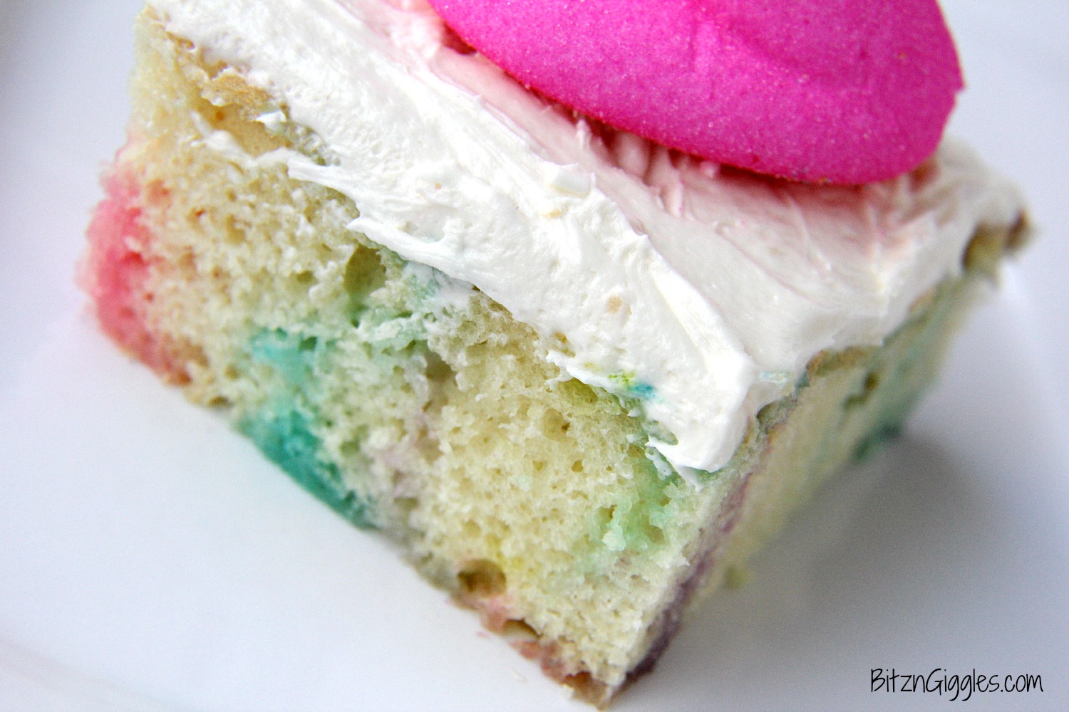 Peeps Cake With Marshmallow Frosting - This cake incorporates bits of Peeps right into the baking process, producing a colorful and slightly sweetened cake with a fluffy, marshmallow frosting that literally melts in your mouth!