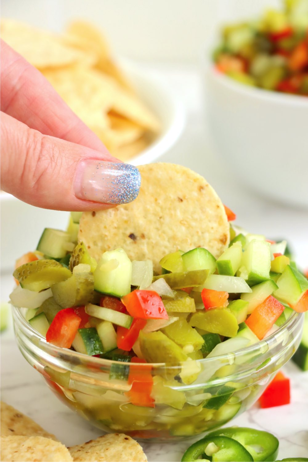 chip being dipped in pickle relish
