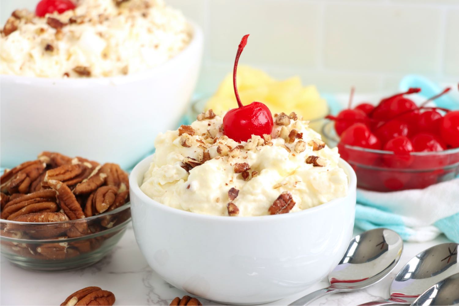 small white bowl of sweet pina colada fluff salad