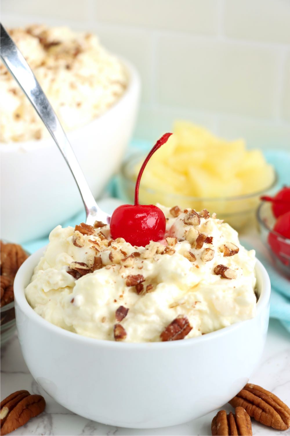 a bowl of fluff salad with a spoon inserted