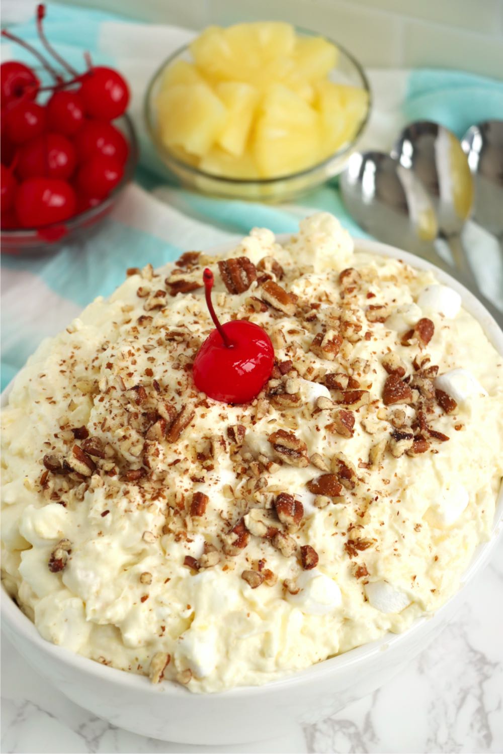 fruit salad topped with crushed nuts and a cherry