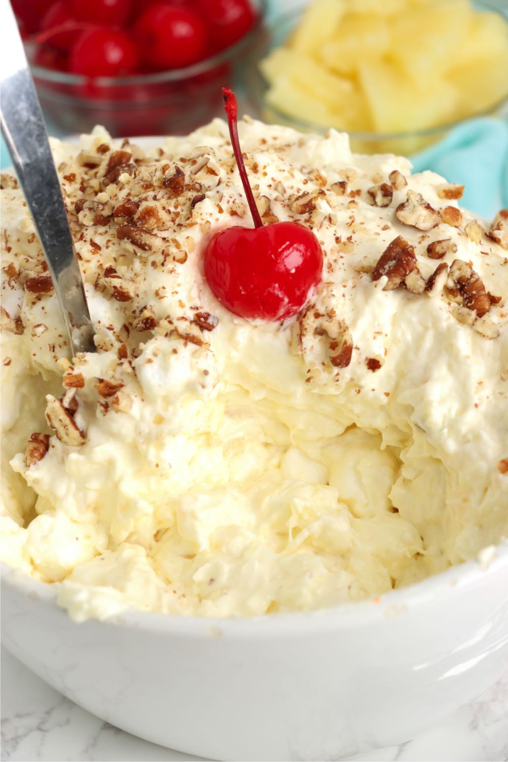 serving spoon in a bowl of pina colada fluff