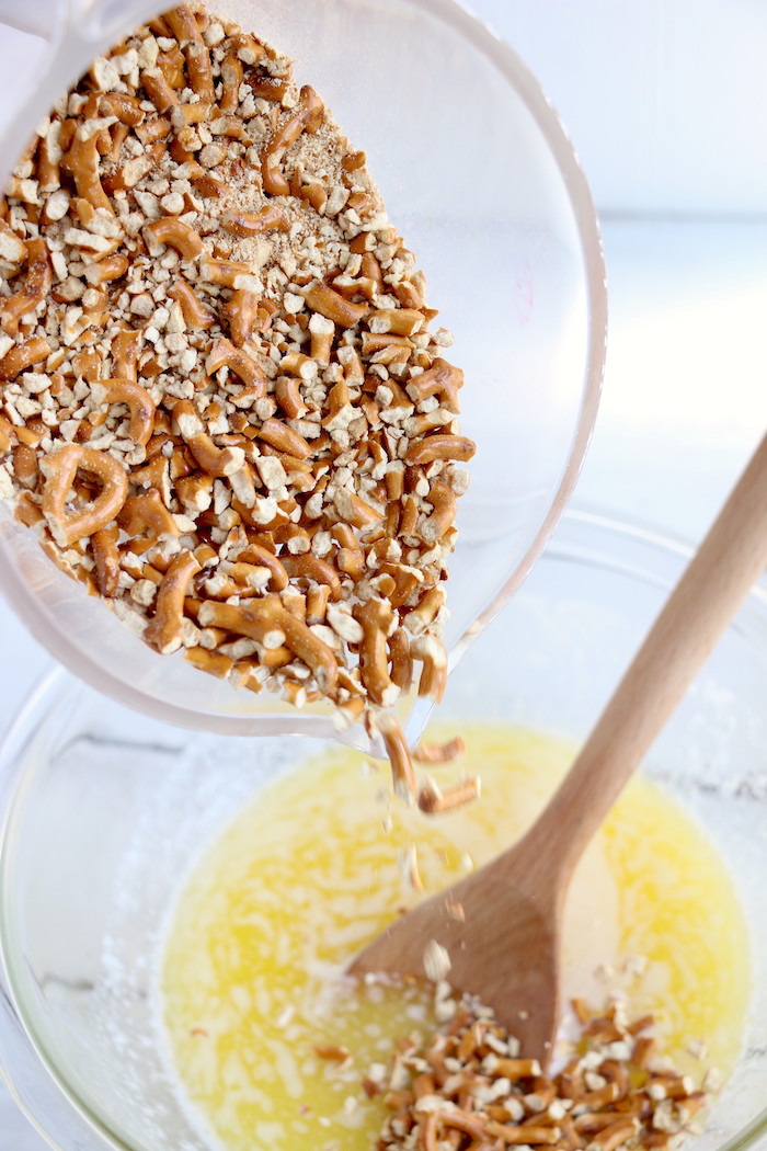 Pineapple Pretzel Salad - This cool, creamy pineapple fluff filled with candied pretzels is the perfect combination of sweet and salty, and can be served as a dessert or sweet side dish!Â