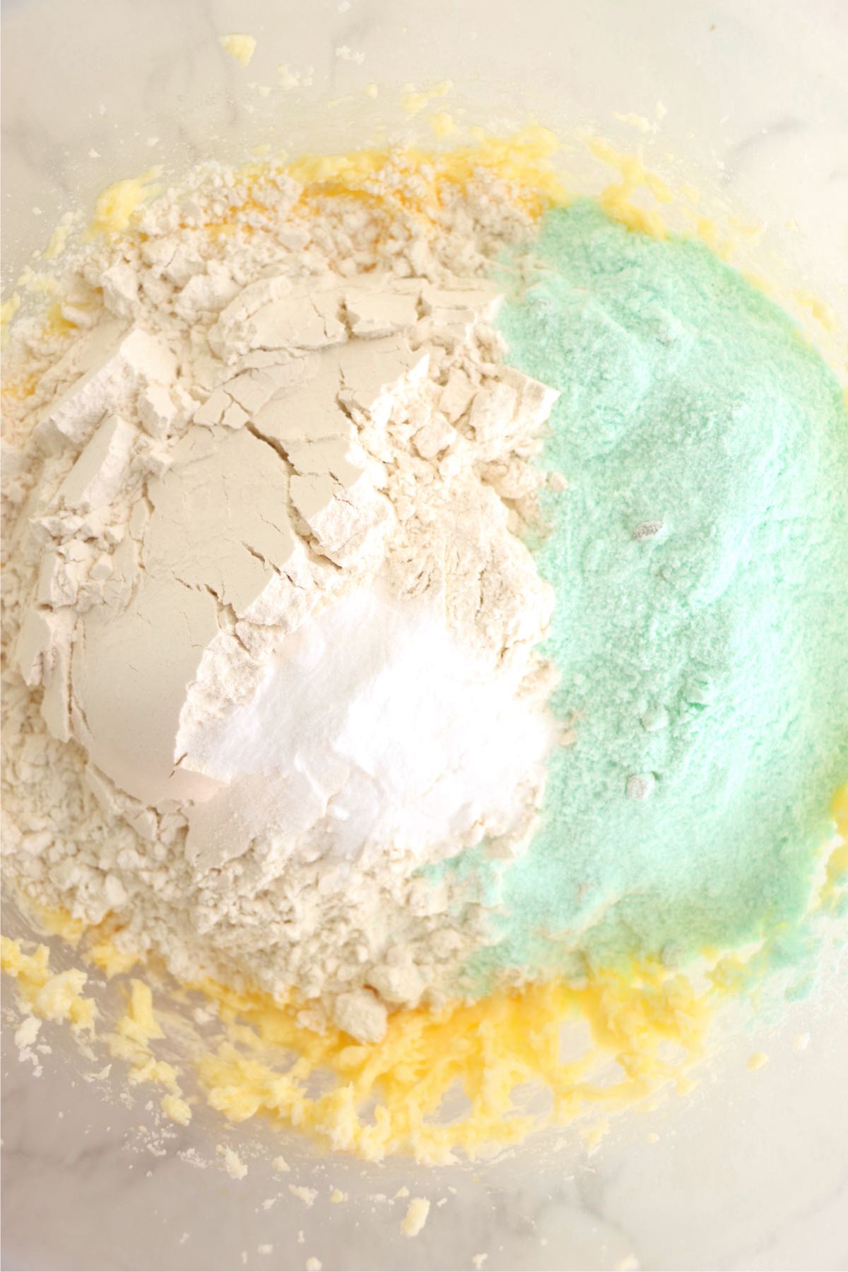Pistachio pudding mix, flour and baking soda in a mixing bowl with softened butter