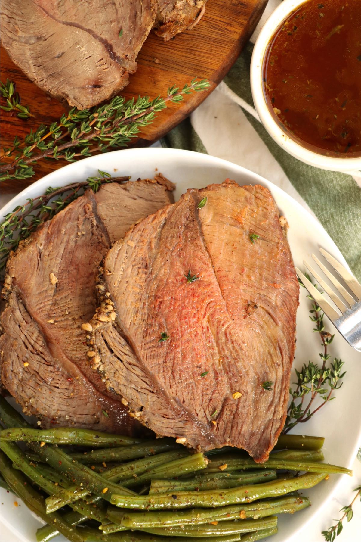 white plate with two pieces of prime rib