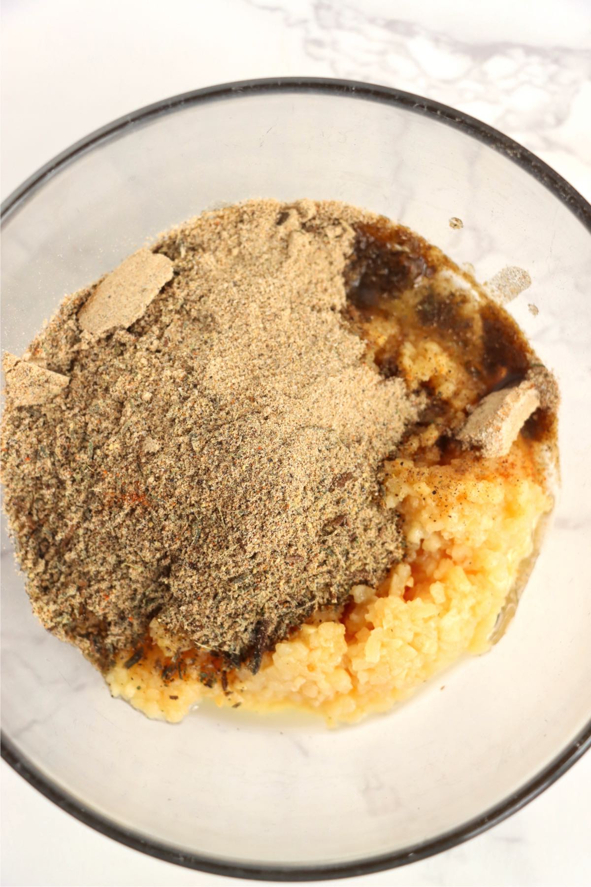 glass bowl filled with sides and olive oil