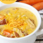 Potato Corn Chowder - Just like Grandma used to make! This flavorful combination of potatoes, corn, carrots and bacon in a creamy, cheesy broth is perfect for the whole family!