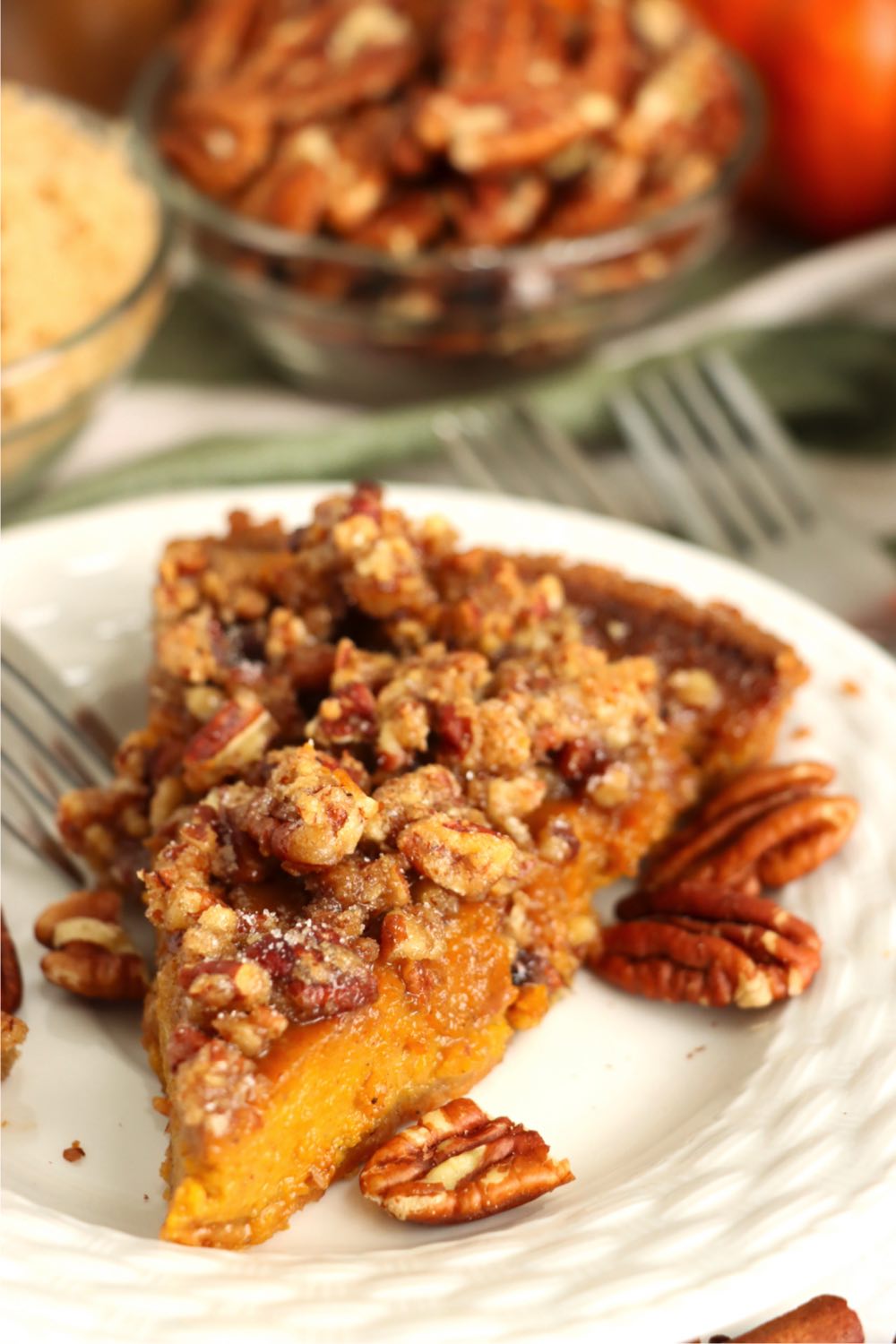 piece of pumpkin pie with praline topping on a plate
