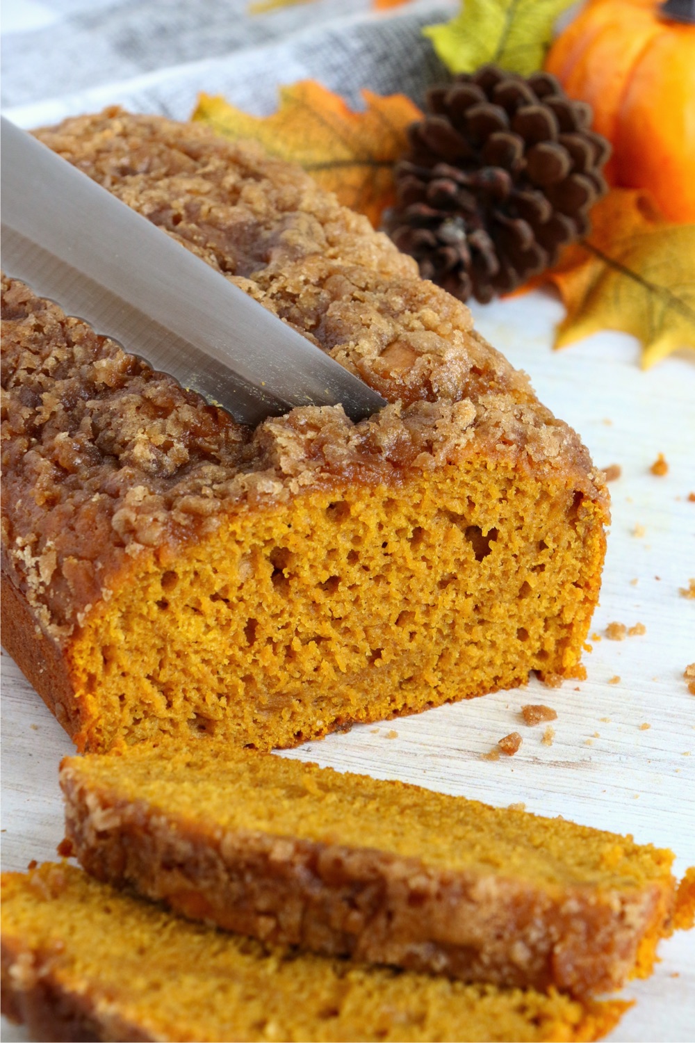 slicing a piece of pumpkin bread