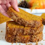 lifting up a piece of pumpkin bread