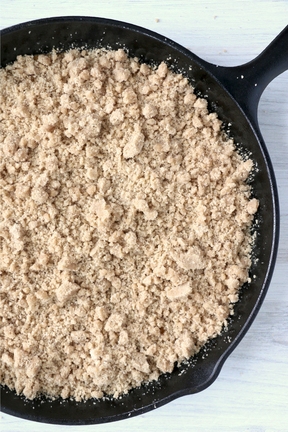 streusel on top of an unbaked pumpkin crisp