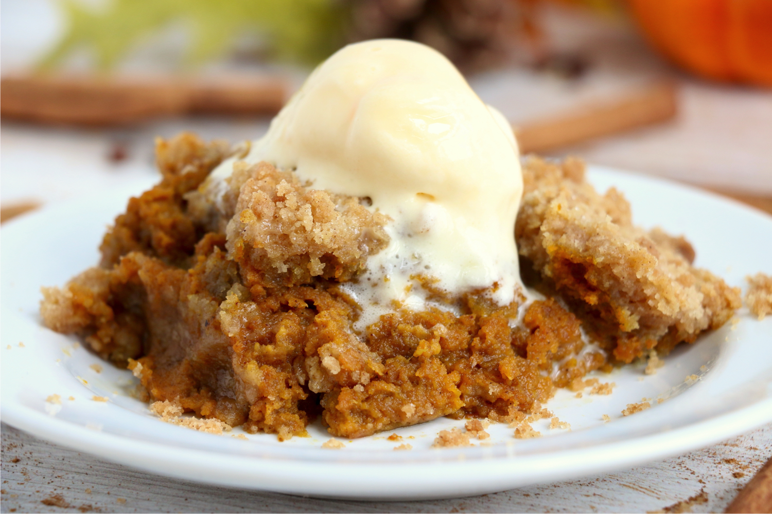 piece of pumpkin crisp on plate with scoop of ice cream