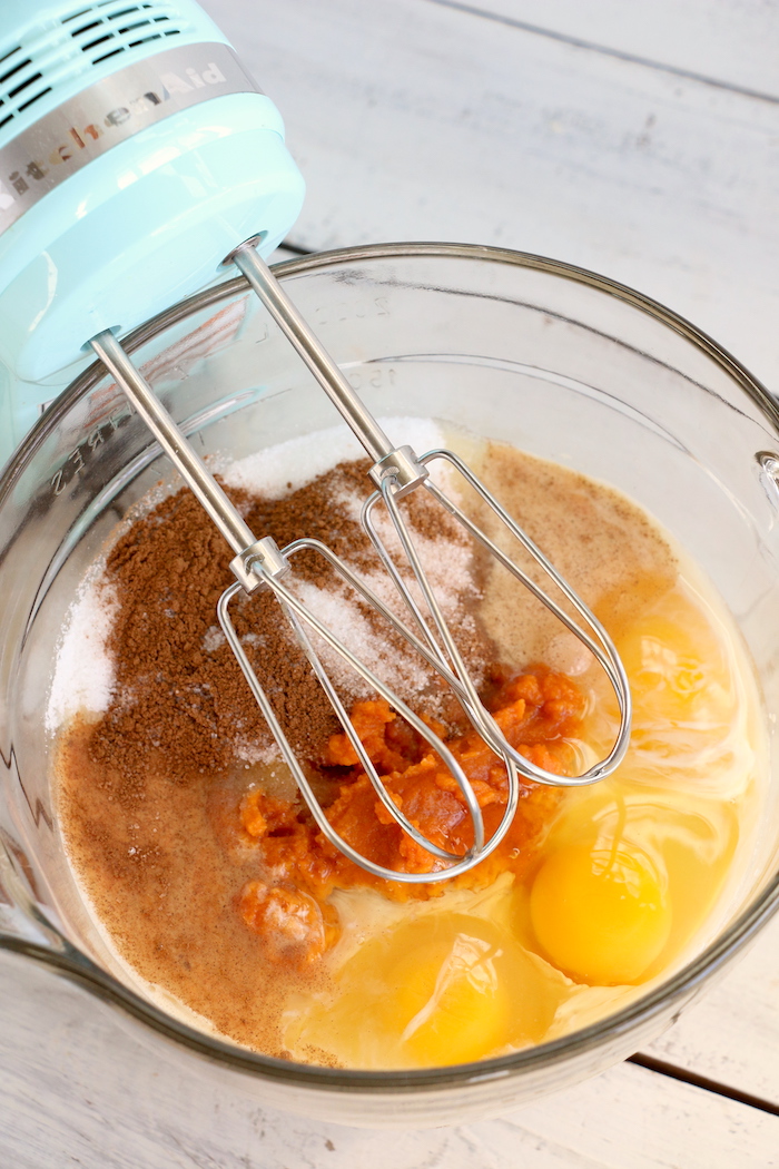 Mixing pumpkin dump cake ingredients