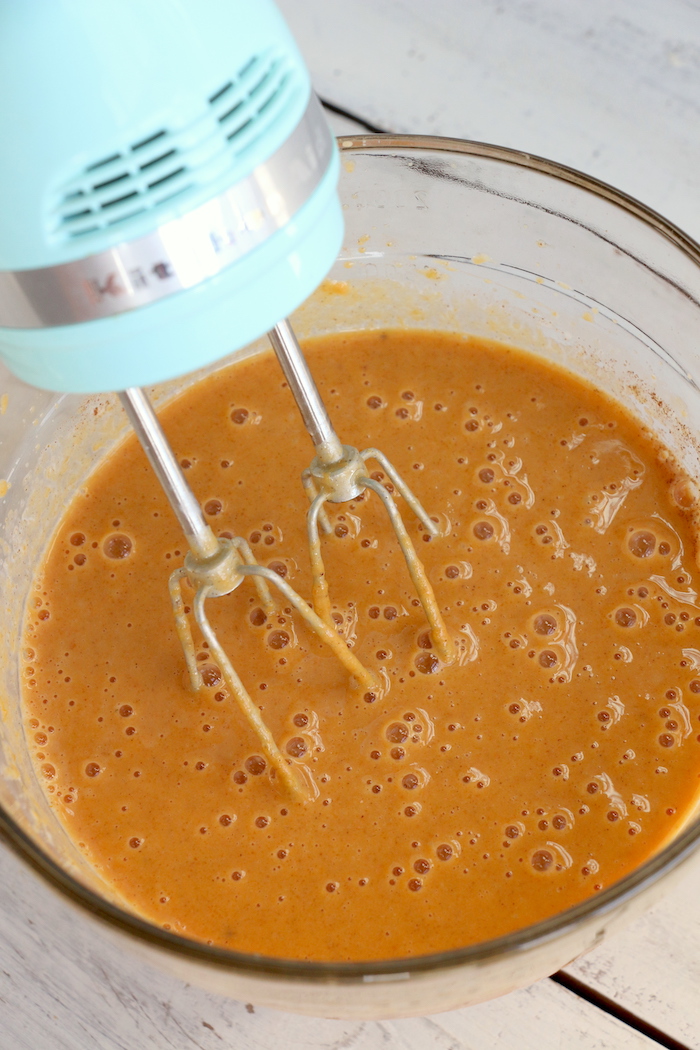 Pumpkin Dump Cake - An easy and delicious pumpkin spice cake topped with vanilla ice cream and caramel drizzle!