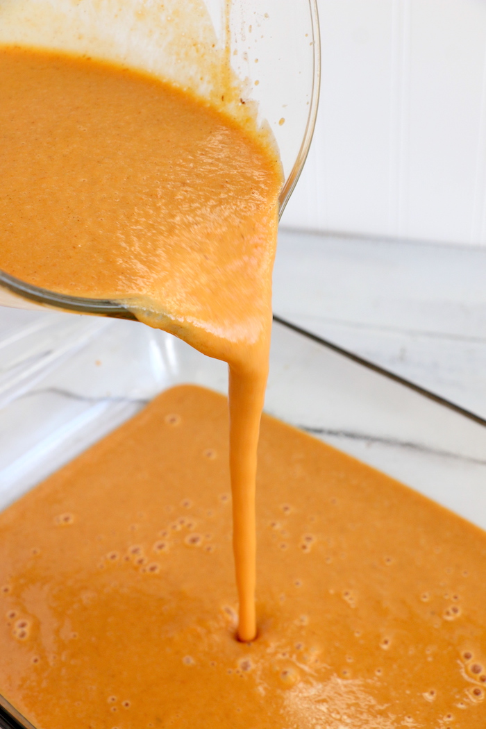 Pumpkin Dump Cake - An easy and delicious pumpkin spice cake topped with vanilla ice cream and caramel drizzle!