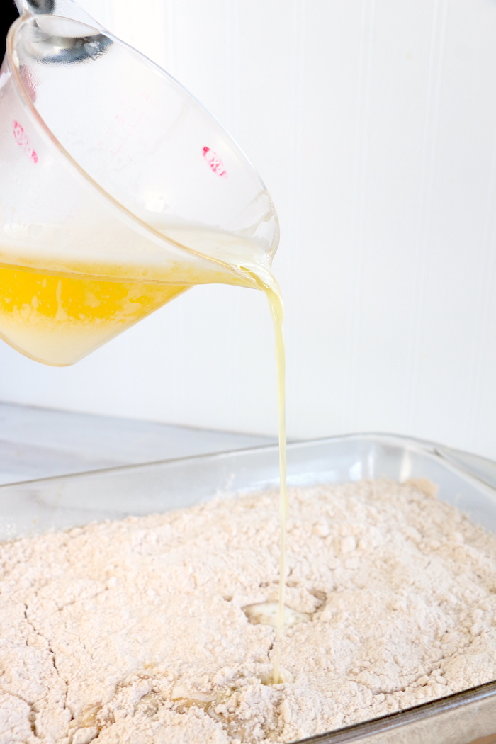 Pumpkin Dump Cake - An easy and delicious pumpkin spice cake topped with vanilla ice cream and caramel drizzle!