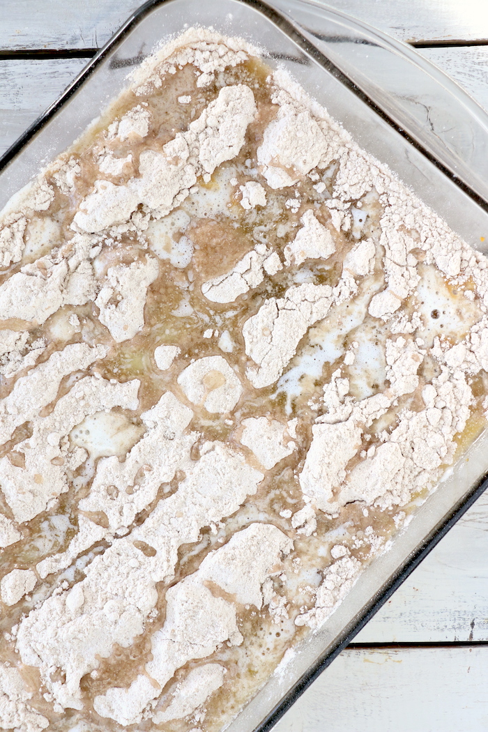 Pumpkin Dump Cake - An easy and delicious pumpkin spice cake topped with vanilla ice cream and caramel drizzle!