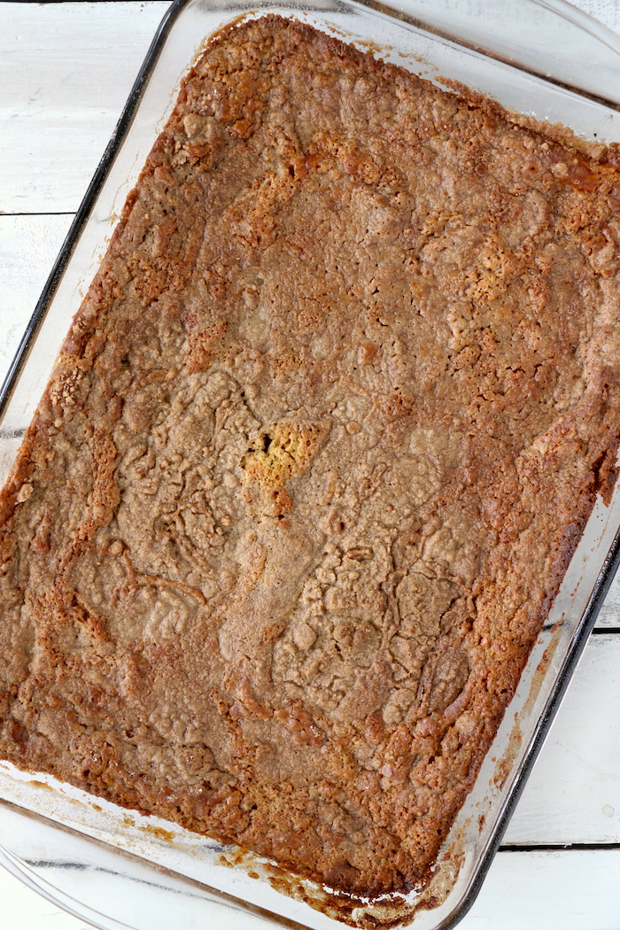 Pumpkin Dump Cake - An easy and delicious pumpkin spice cake topped with vanilla ice cream and caramel drizzle!