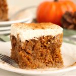 piece of pumpkin poke cake garnished with cinnamon