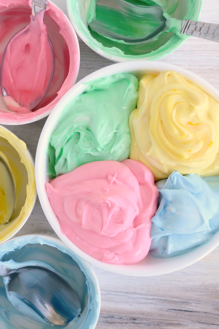 Making rainbow fruit dip in a bowl
