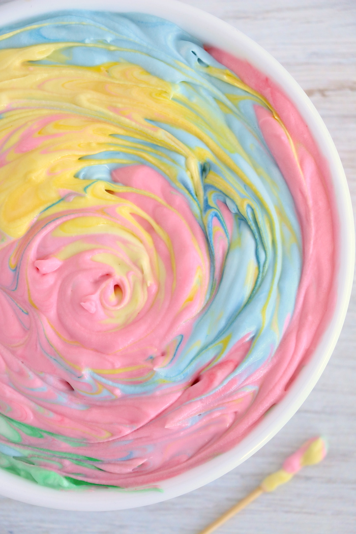 Swirled rainbow fruit dip in a white bowl