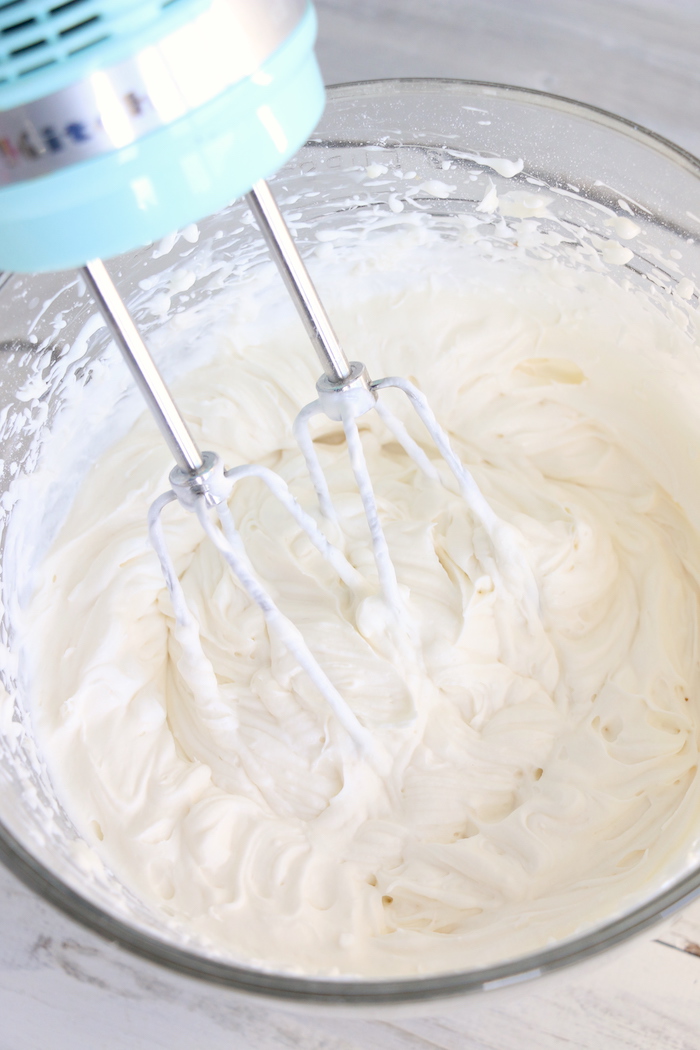 Mixing together fruit dip in a glass bowl