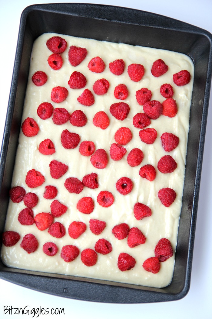 Warm Raspberry Cake with Vanilla Glaze - just like your mom used to make! A delicious cake with fresh raspberries baked in and topped with a sweet vanilla glaze!