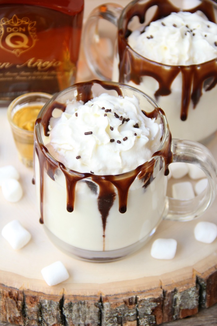 Rum & White Chocolate Hot Cocoa - a heavenly combination of white chocolate, rum, marshmallows, drizzles of chocolate and a big swirl of whipped cream topped with sprinkles is the ultimate fall indulgence!